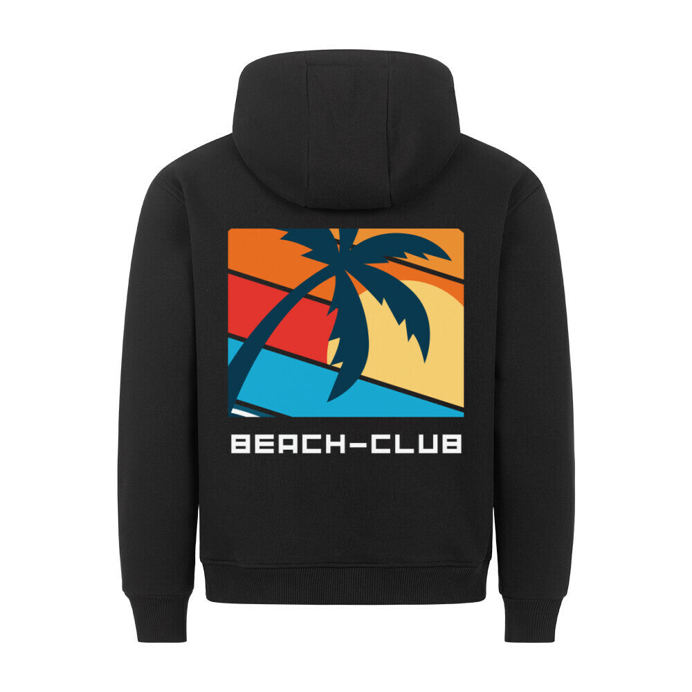 Der Premium Hoodie "Beach-Club" von MarketPrint ist ein schwarzes Sweatshirt in lockerer Passform mit einer auffälligen Palmen-Silhouette über einem farbenfrohen Sonnenuntergang und dem Text BEACH-CLUB auf dem Rücken. Hergestellt in Türkiye.