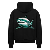 Der Oversized Zipper Hoodie "Hai" von MarketPrint ist ein schwarzer Premium-Kapuzenpulli im Oversized-Schnitt mit einer auffälligen Hai-Grafik in Grün und Weiß auf dem Rücken. Hergestellt aus 100% Baumwolle für Komfort und Stil.