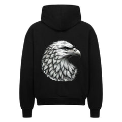 Der Oversized Zipper Hoodie "Adler" von MarketPrint ist ein schwarzer Premium-Kapuzenpulli in Oversized-Passform, der auf dem Rücken eine detailreiche weiß-graue Adlerkopf-Illustration groß aufgedruckt hat.