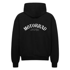 Der MarketPrint Oversized Zipper Hoodie "Motorrad Lifestyle" besticht durch einen fetten, weißen Bogenschriftzug auf dem Rücken und einen übergroßen Schnitt. Hergestellt aus 100% Baumwolle, bietet er Komfort und Stil.
