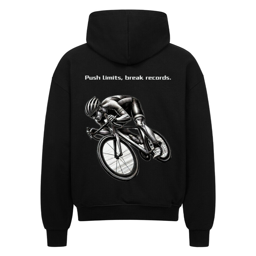 Der Oversized Zipper Hoodie "Radsport" von MarketPrint ist ein schwarzer Premium-Kapuzenpullover mit einer Graustufen-Radfahrergrafik und dem Slogan "Push limits, break records." darüber auf dem Rücken.