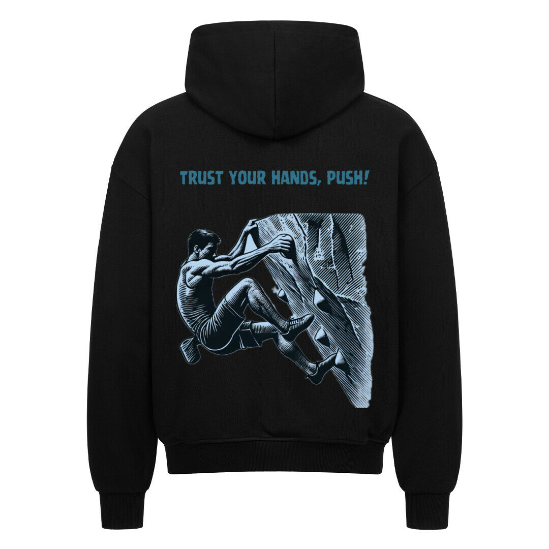 Der Oversized Zipper Hoodie "Bouldern" von MarketPrint ist aus 100% Baumwolle gefertigt und zeigt einen fetten Rückenprint eines Kletterers mit "TRUST YOUR HANDS, PUSH!" über der Illustration.