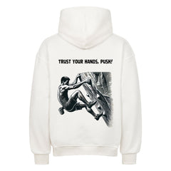 Der MarketPrint Oversized Hoodie "Bouldern" zeigt eine schwarz-weiße Kletterillustration mit dem Aufdruck "TRUST YOUR HANDS, PUSH!" über dem Bild auf dem Rücken.