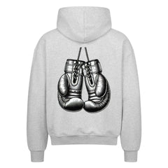 Der MarketPrint Oversized Zipper Hoodie "Boxhandschuhe" in Hellgrau hat eine schwarz-weiße Boxhandschuh-Grafik auf dem Rücken und besteht aus 100% Baumwolle für Komfort und Stil.