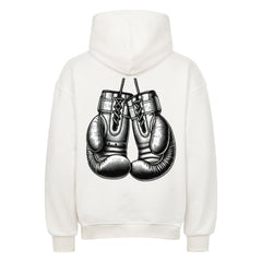 Der MarketPrint Oversized Hoodie "Boxhandschuhe" ist ein weißer Premium-Kapuzenpullover mit einem Rückendruck von hängenden Boxhandschuhen.
