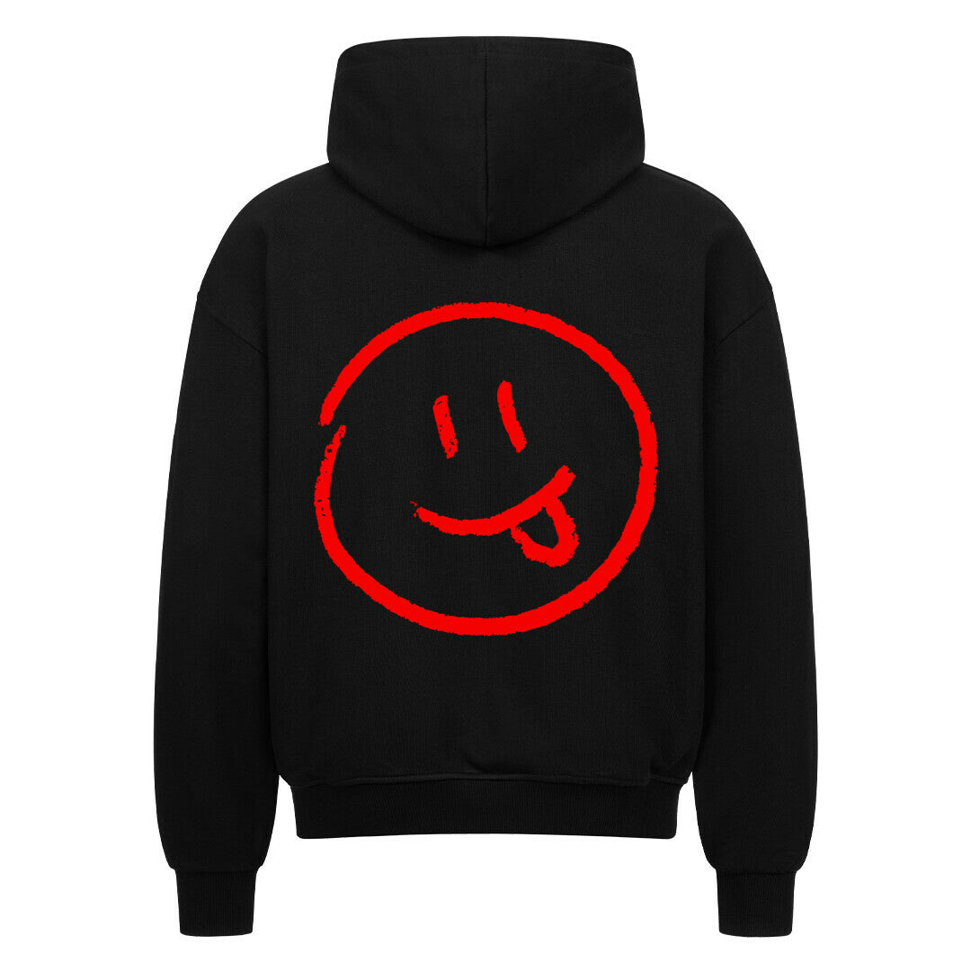 Der MarketPrint Oversized Zipper Hoodie "Smiley" zeigt ein großes rotes Smiley-Gesicht mit herausgestreckter Zunge auf dem Rücken und bietet einen auffallend lässigen Stil in kräftigem Schwarz.