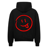Der MarketPrint Oversized Zipper Hoodie "Smiley" zeigt ein großes rotes Smiley-Gesicht mit herausgestreckter Zunge auf dem Rücken und bietet einen auffallend lässigen Stil in kräftigem Schwarz.