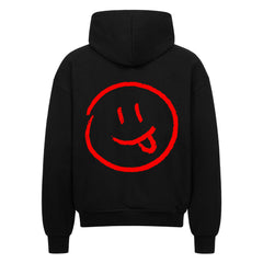 Der MarketPrint Oversized Zipper Hoodie "Smiley" zeigt ein großes rotes Smiley-Gesicht mit herausgestreckter Zunge auf dem Rücken und bietet einen auffallend lässigen Stil in kräftigem Schwarz.