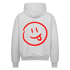 Der Oversized Zipper Hoodie "Smiley" von MarketPrint ist ein hellgrauer Premium-Baumwoll-Kapuzenpullover mit einer großen roten Smiley-Grafik und einem verspielten Gesichtsausdruck auf dem Rücken.