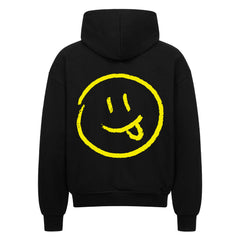 Der MarketPrint Oversized Zipper Hoodie "Smiley" ist ein schwarzer Kapuzenpulli aus 100% Baumwolle mit einer übergroßen Passform und einer großen gelben Smiley-Grafik auf dem Rücken.