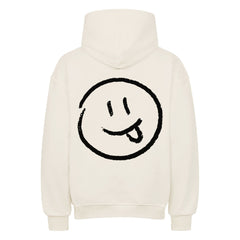 Der Oversized Hoodie "Smiley" von MarketPrint ist cremefarben und zeigt auf der Rückseite ein schwarz umrandetes Smiley-Gesicht (Zunge raus). Er hat lange Ärmel und eine Kapuze.