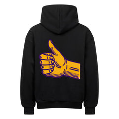 Der MarketPrint Oversized Hoodie "Daum hoch" in Schwarz zeigt eine große gelbe Daumen-hoch-Hand mit lila Umrissen auf dem Rücken, die sich vor einem weißen Hintergrund abzeichnet.
