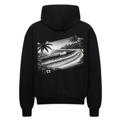 Der Infinity Merch Oversized Zipper Hoodie "Strand" in Schwarz zeigt auf der Rückseite eine monochrome Grafik von Meereswellen, Palmen und tropischen Pflanzen in einem Rechteck. Hergestellt aus 100% Baumwolle für Komfort und Haltbarkeit.