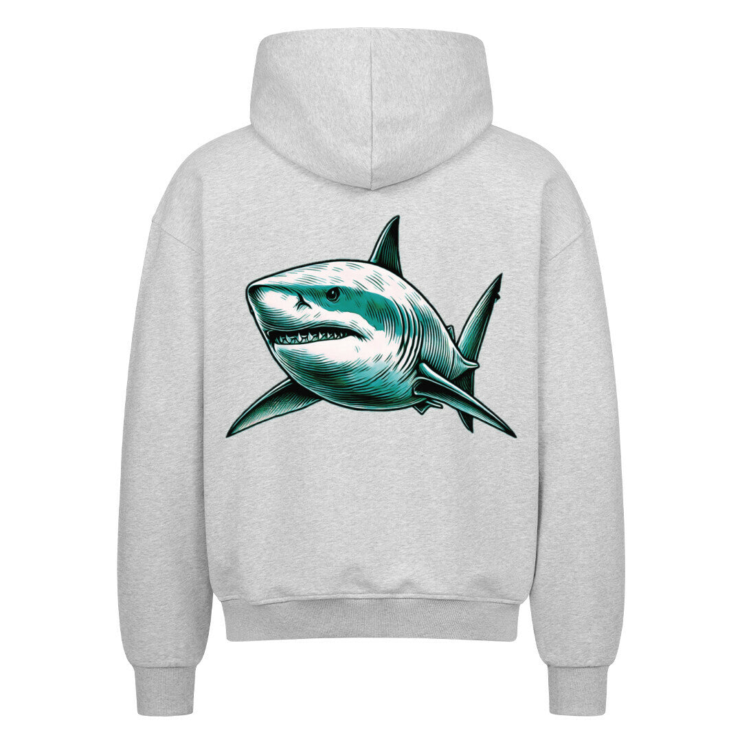 Der MarketPrint Oversized Zipper Hoodie "Hai" ist in Hellgrau gehalten und zeigt eine auffällige, detaillierte Hai-Grafik in Teal und Schwarz auf dem Rücken, wobei das Maul des Hais leicht geöffnet ist und scharfe Zähne zeigt.