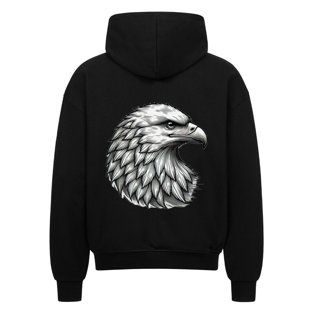 Der Oversized Zipper Hoodie "Adler" von MarketPrint ist ein schwarzer Premium-Kapuzenpulli in Oversized-Passform, der auf dem Rücken eine detailreiche weiß-graue Adlerkopf-Illustration groß aufgedruckt hat.
