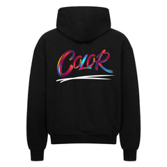 Der MarketPrint Oversized Zipper Hoodie "COLOR" besteht aus schwarzer Premium-Baumwolle (100%) mit dem Schriftzug "Color" in mehrfarbiger Pinselstrich-Schrift und einer weißen Swipe-Grafik auf der Rückseite und bietet sowohl Komfort als auch einen auffälligen Stil.