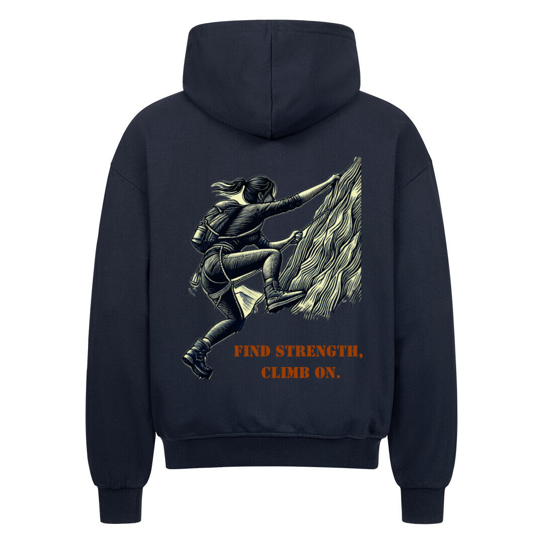 Der MarketPrint Oversized Zipper Hoodie "Find strength, climb on." in schwarz besteht aus 100% Baumwolle und zeigt eine Klettergrafik mit fetter, orangefarbener Schrift unter der Illustration.