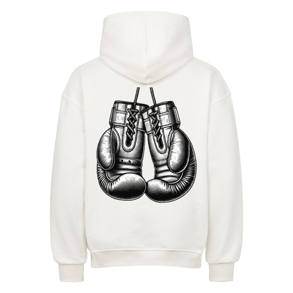 Der MarketPrint Oversized Hoodie "Boxhandschuhe" ist ein weißer Premium-Kapuzenpullover mit einem Rückendruck von hängenden Boxhandschuhen.