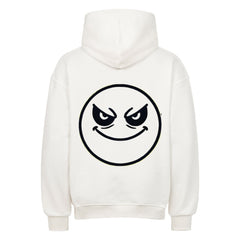 Der Oversized Hoodie "Böser-smiley" von MarketPrint ist ein weißer Premium-Kapuzenpullover mit einem großen schwarzen Umriss eines schelmischen Smileys und einem verschmitzten Grinsen auf dem Rücken.