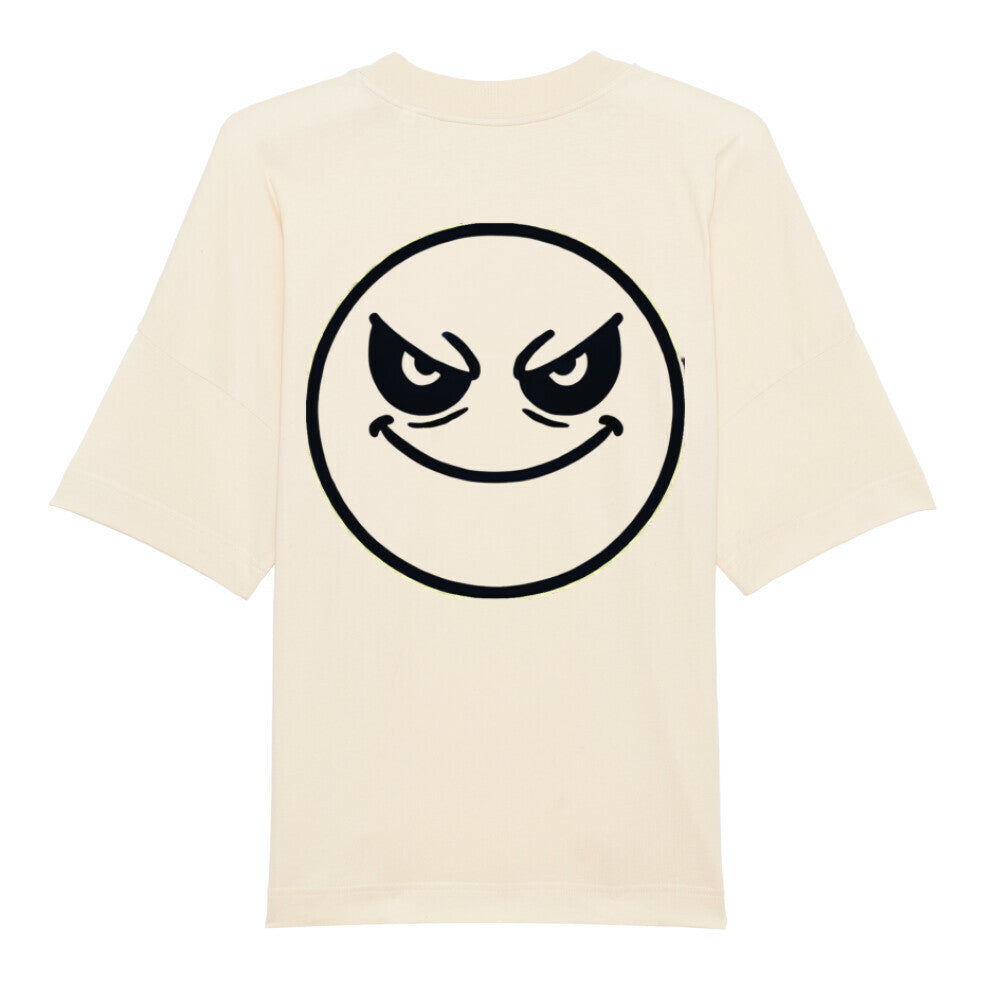 Das Premium Oversize Blast "Böser-smiley" T-Shirt von MarketPrint ist beige, aus Bio-Baumwolle, hat kurze Ärmel und auf dem Rücken einen großen schwarzen Umriss eines frechen Smileys mit schrägen Augen.