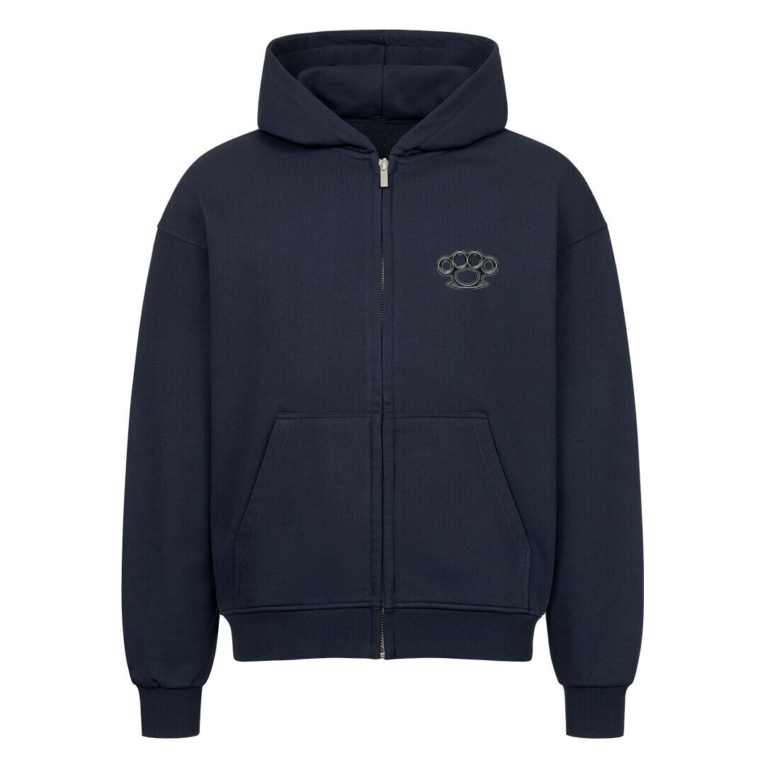 Der Oversized Zipper Hoodie "Schlagring" von MarketPrint ist schwarz, aus 100% Baumwolle, mit einem übergroßen Schnitt, Fronttasche, kleiner Schlagring-Brustgrafik, Kapuze und gerippten Bündchen und Saum.