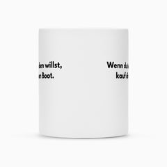 Die abgebildete weiße Tasse "Treiben" von Infinity Merch mit Duraglaze-Beschichtung zeigt teilweise lesbaren schwarzen deutschen Text auf beiden Seiten. Der restliche Text ist aus diesem Blickwinkel nicht vollständig sichtbar.